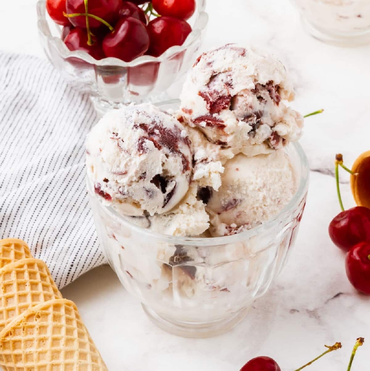 Cherry ice cream scoops in a clear glass bowl