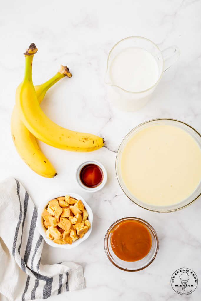 Ingredients for banoffee ice cream, in separate dishes on a marble countertop.