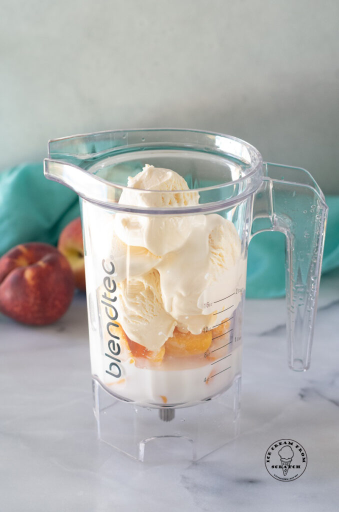 ingredients for a peach milkshake in a blender jar