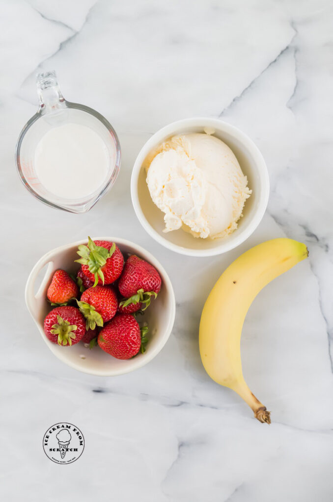 top down view of ingredients in a strawberry banana milkshake
