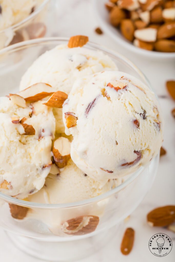 a glass ice cream dish filled with almond ice cream.