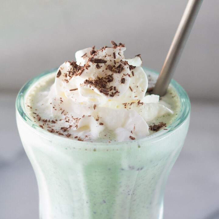 close up of the top of a mint chocolate chip milkshake