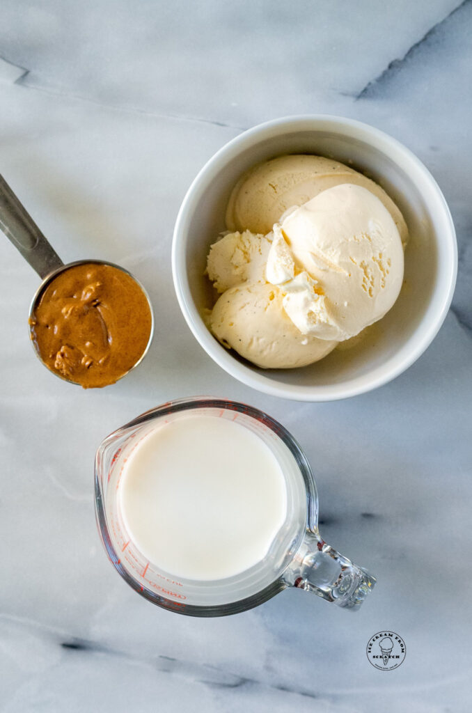 vanilla ice cream, peanut butter and milk in measure cups and bowls