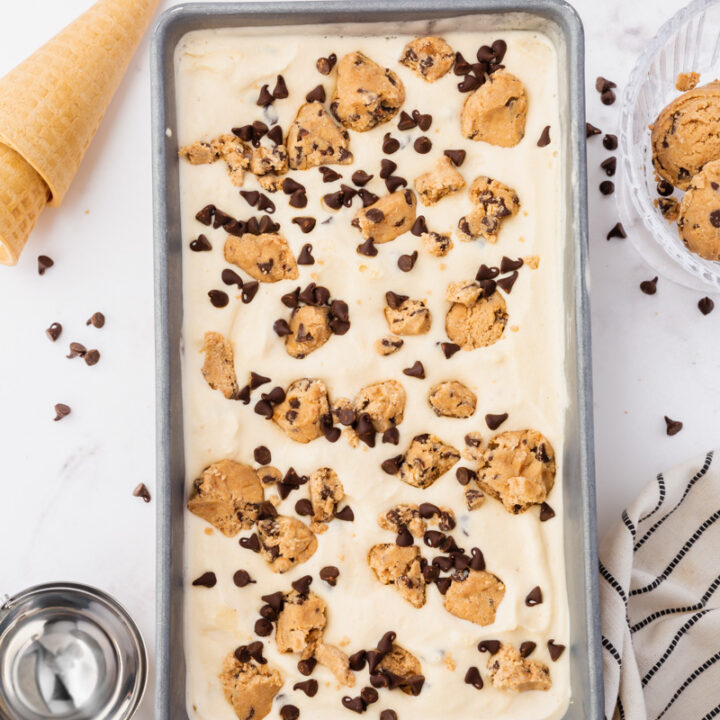 a loaf pan viewed from above, filled with homemade cookie dough ice cream with chocolate chips.