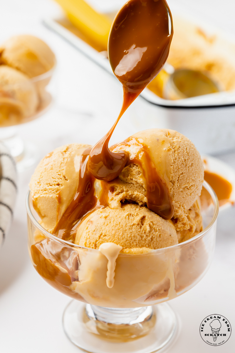 dulce de leche caramel drizzled over a glass dish of dulce de leche ice cream
