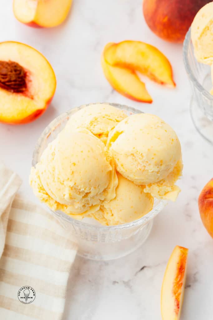 scoops of peaches and cream ice cream in a bowl