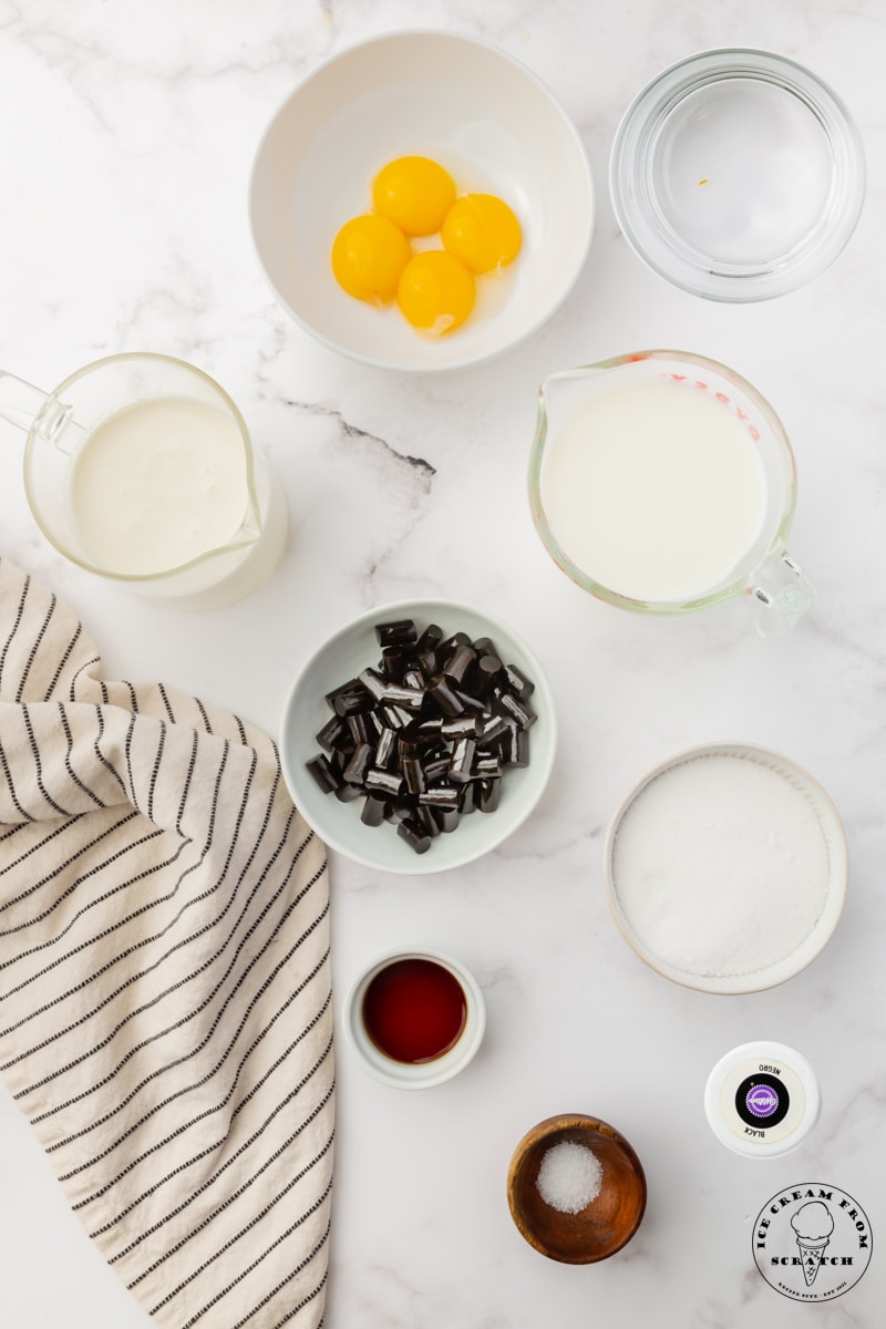 The ingredients in black licorice ice cream, all in separate bowls, viewed from above.