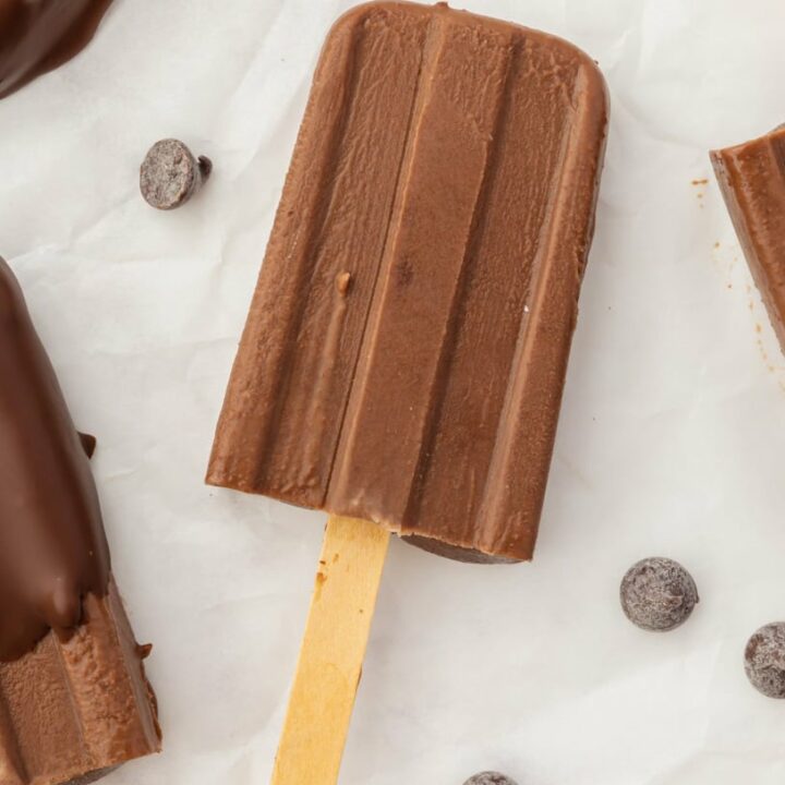 a homemade fudgesicle with chocolate chips near it.