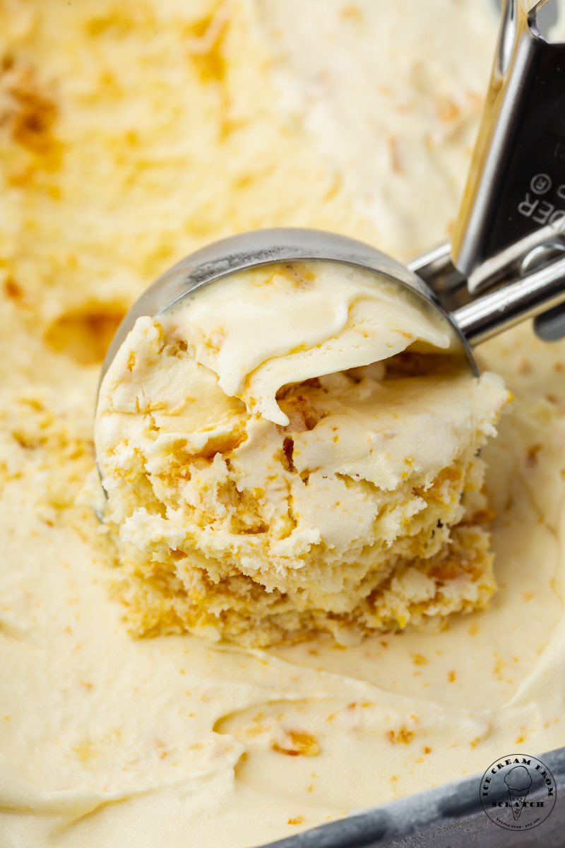 an ice cream scoop pulling a scoop of homemade hokey pokey ice cream