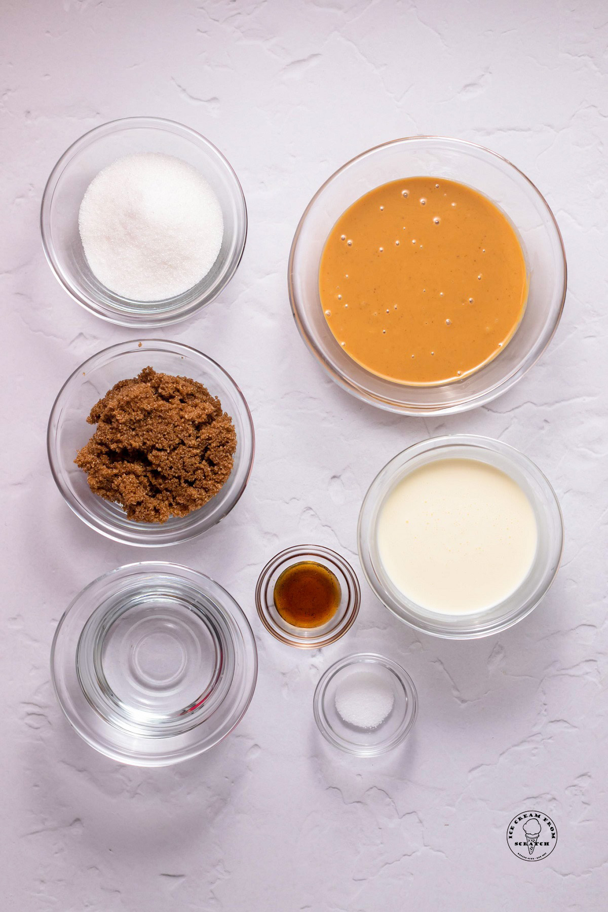 The ingredients needed to make peanut butter ice cream sauce, all in small glass bowls on a counter.