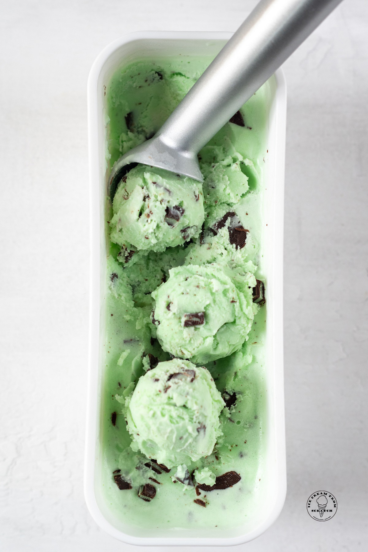 A rectangular white container of homemade andes ice cream, formed into scoops.