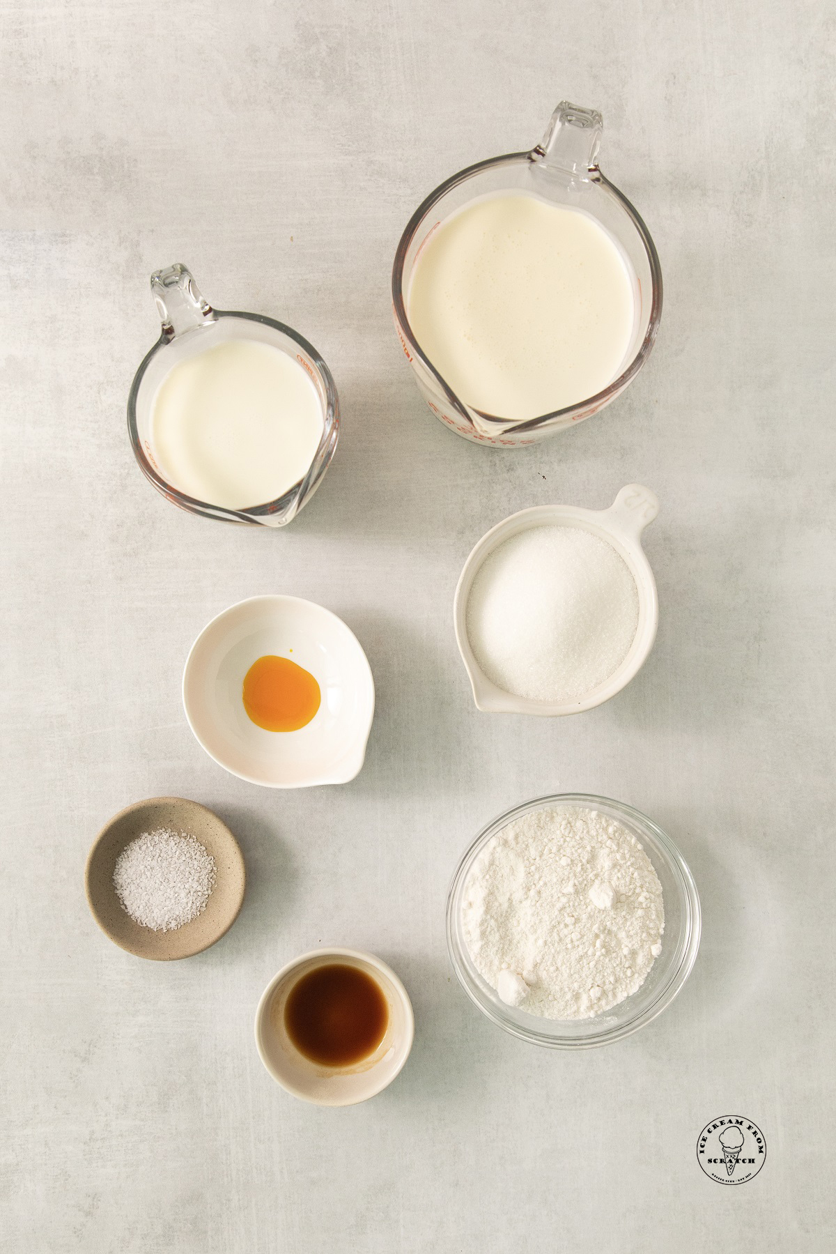 The ingredients needed to make cake batter ice cream without eggs, measured and arranged in separate bowls.