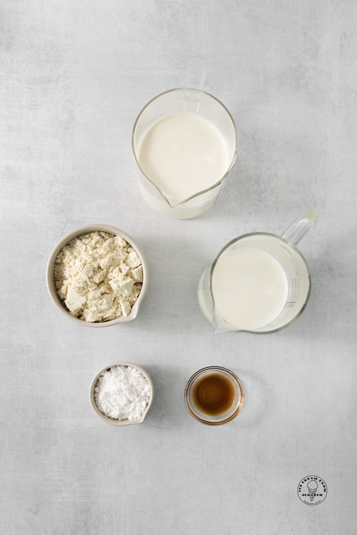 The ingredients for protein ice cream, including protein powder, all in separate bowls on a counter.