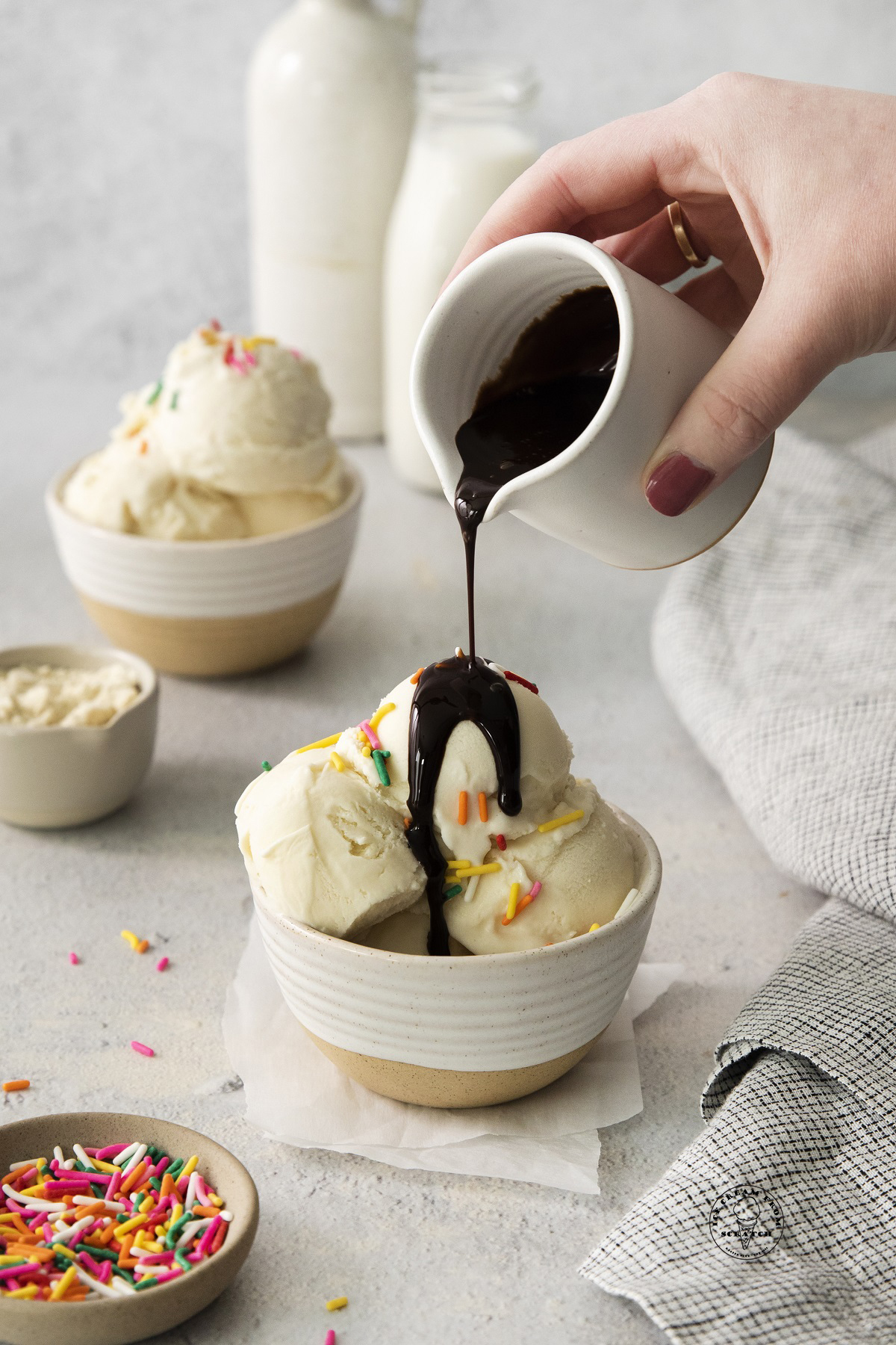 chocolate sauce poured over a bowl of homemade high protein ice cream.
