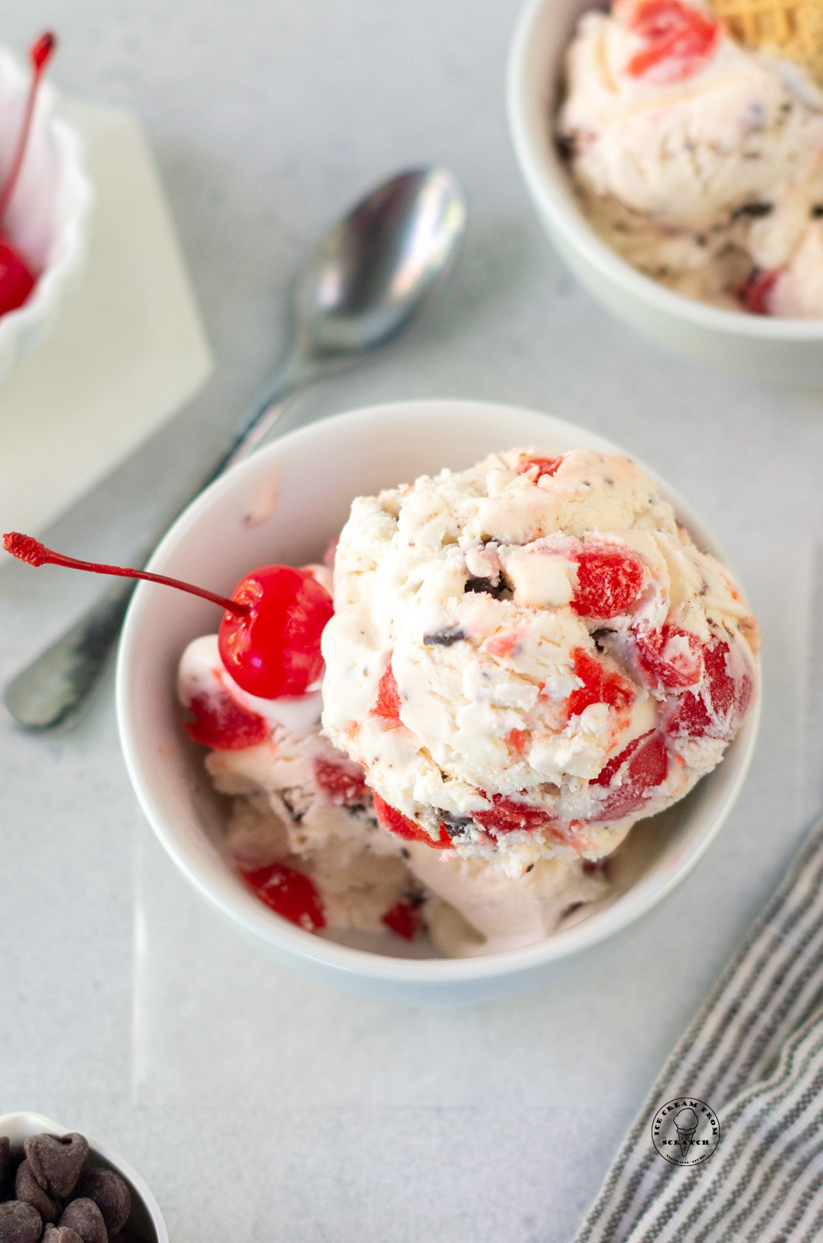 scoops of homemade cherry cordial ice cream in a dish.