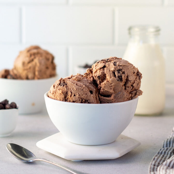 a white bowl holding scoops of homemade chocolate chocolate chip ice cream
