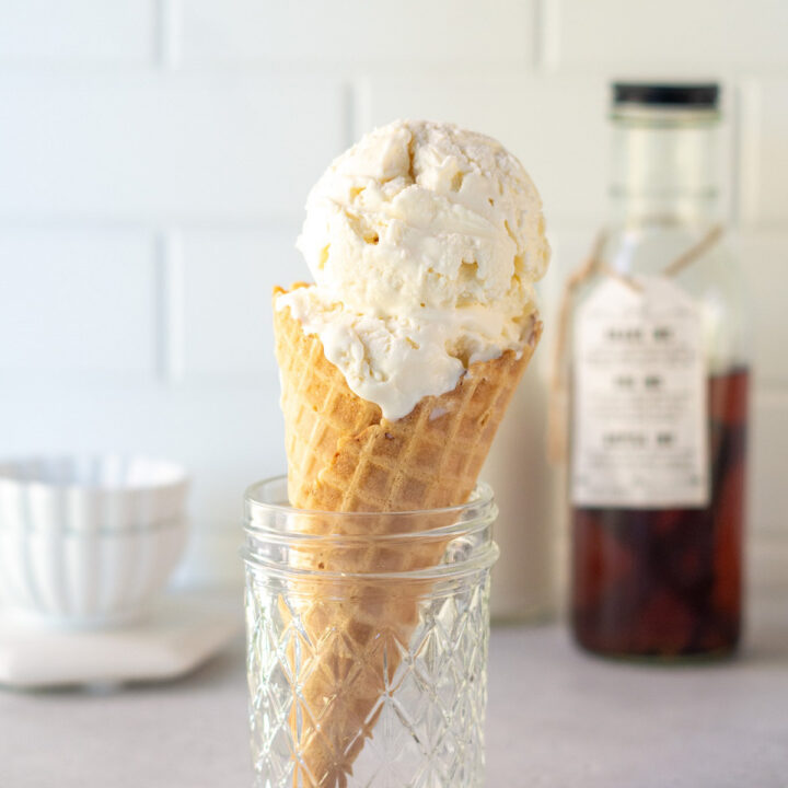 a sugar cone filled with scoops of mexican vanilla ice cream.