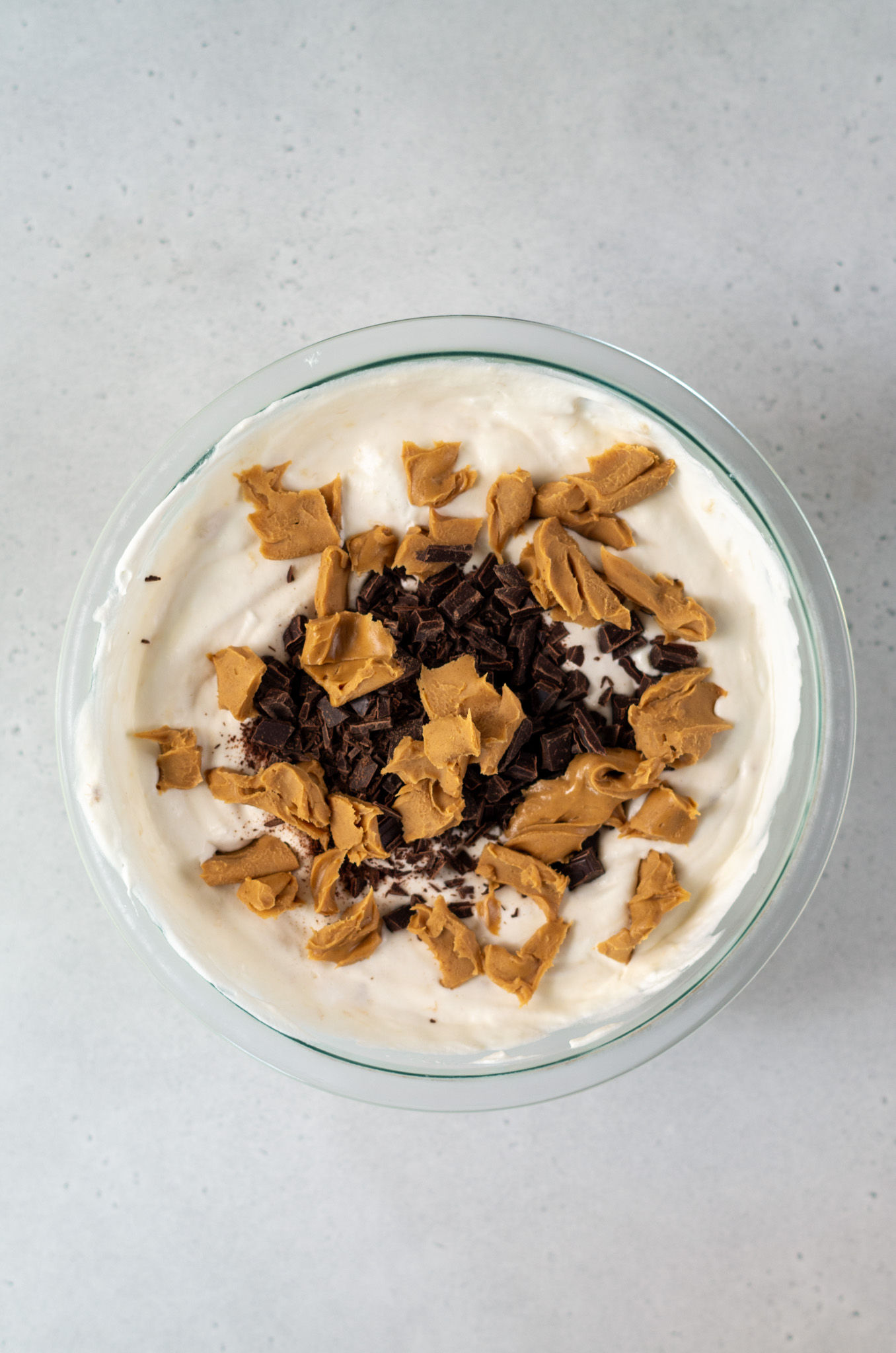 chocolate and peanut butter being mixed into the fat elvis ice cream mixture