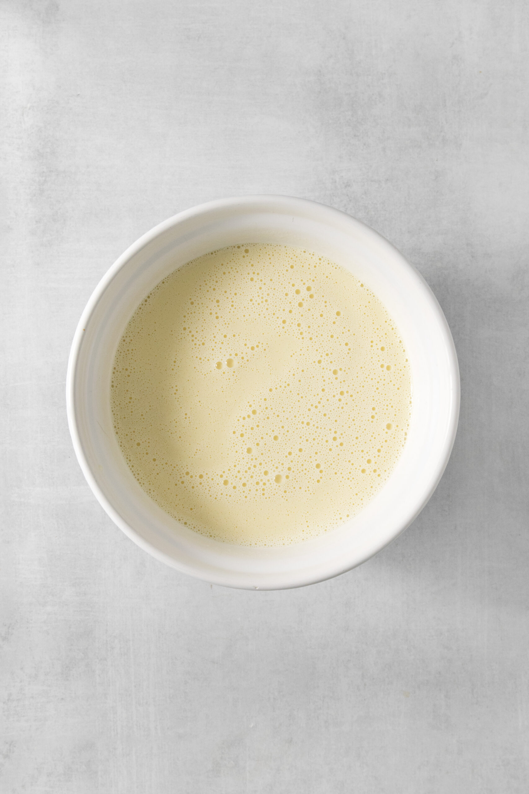 mascarpone heavy cream and vanilla mixed into the ice cream mixture in a bowl
