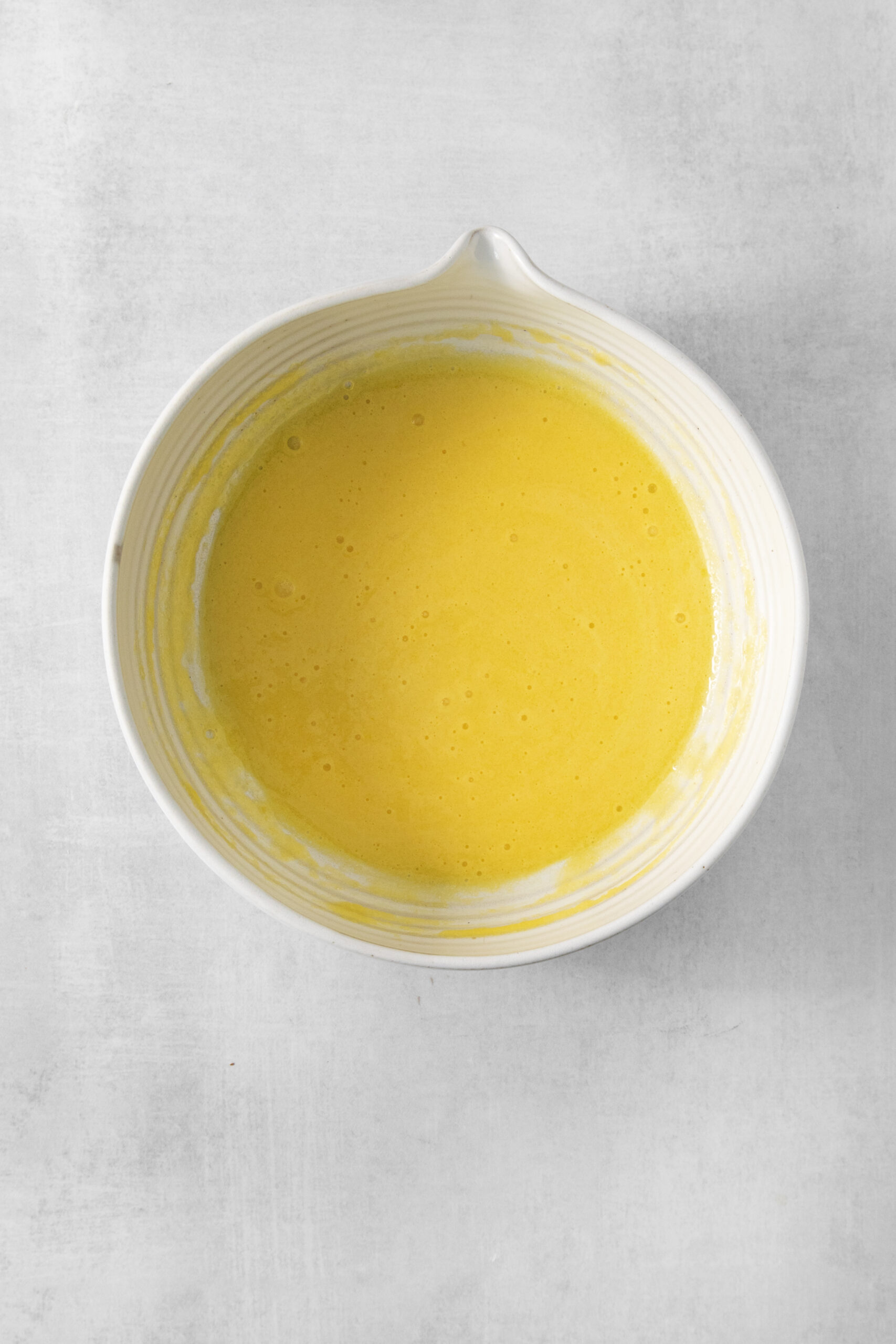sugar and egg yolks mixed together in a bowl