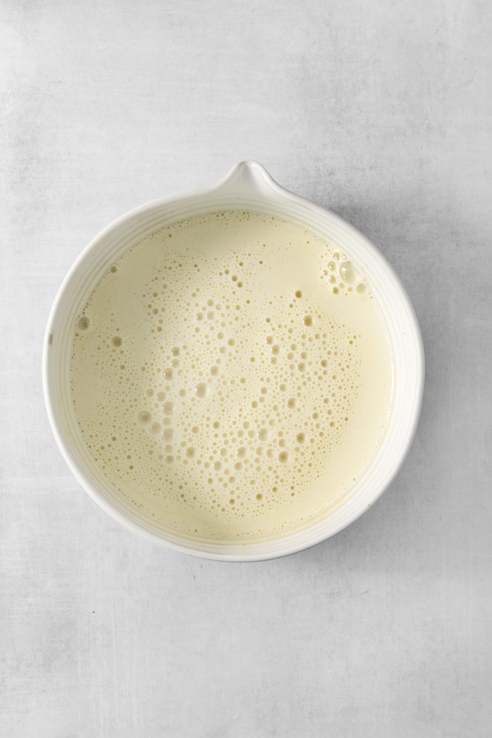 ingredients for earl grey ice cream mixed in a bowl