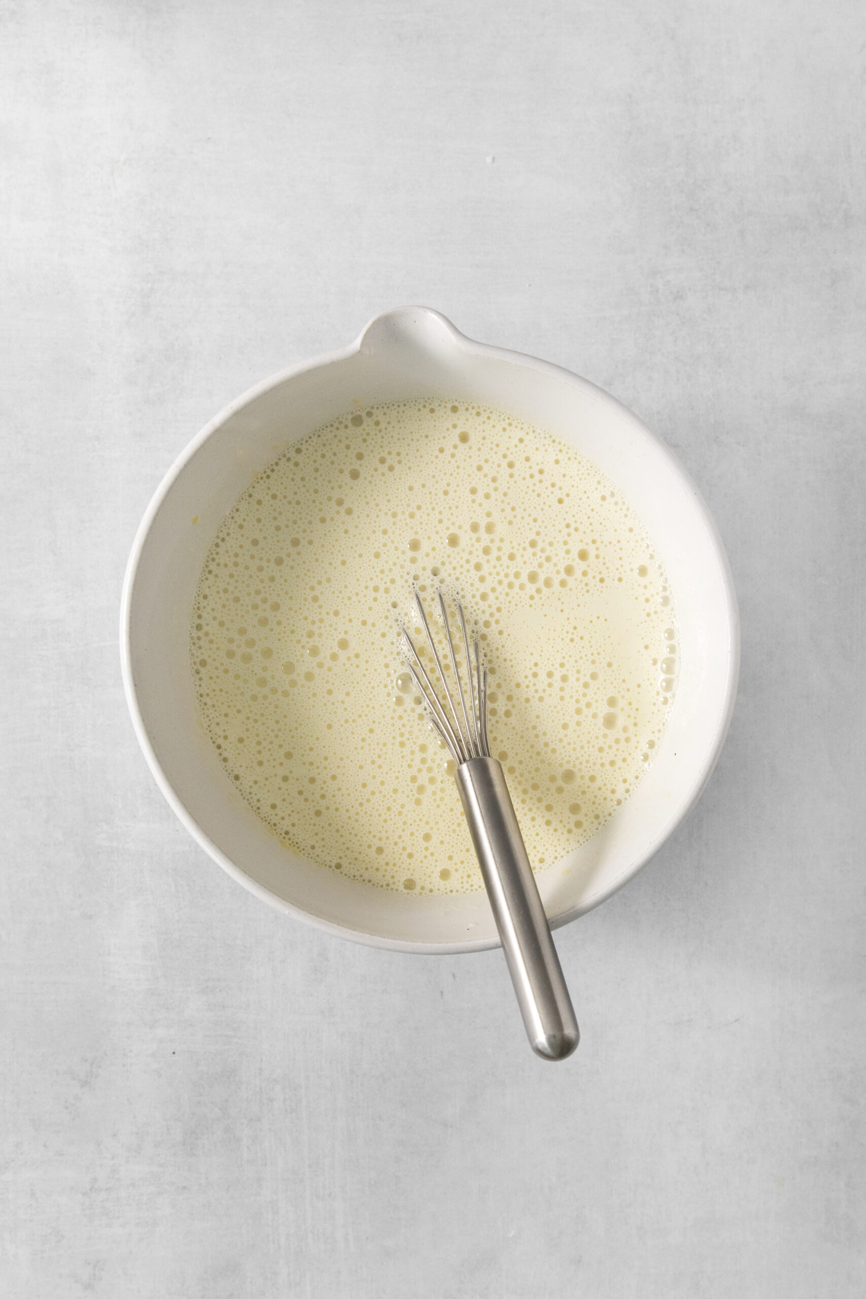 ingredients for earl grey ice cream mixed in a bowl