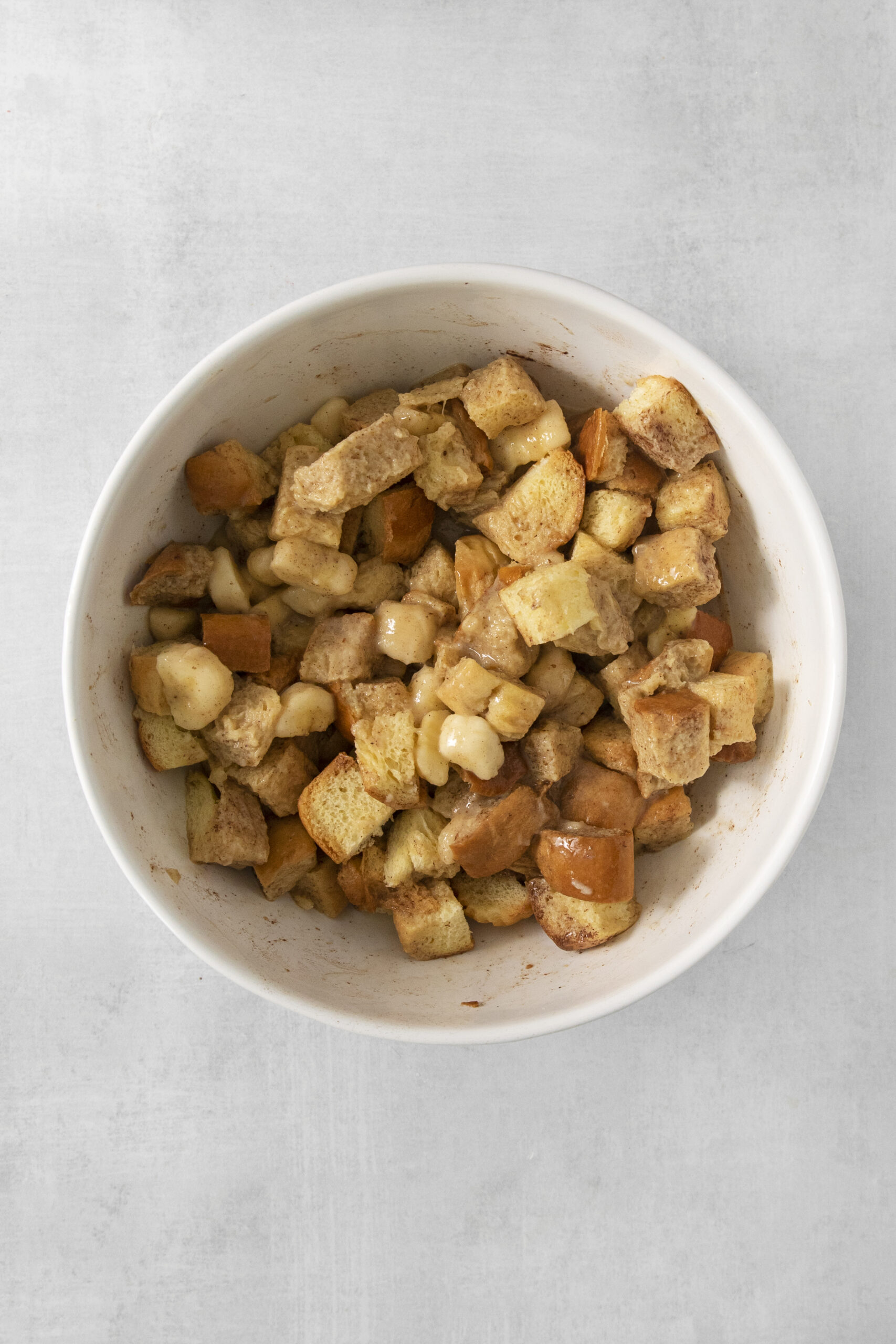 banana bread pudding ingredients mixed in a bowl