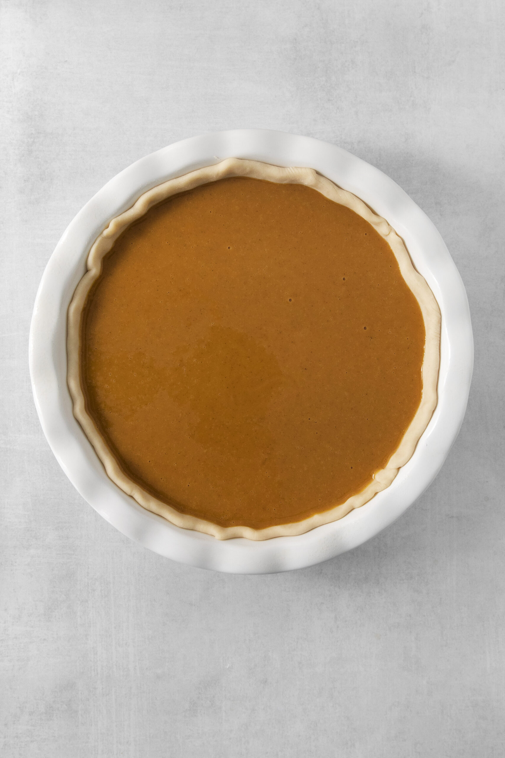 unbaked pumpkin pie in a pie pan
