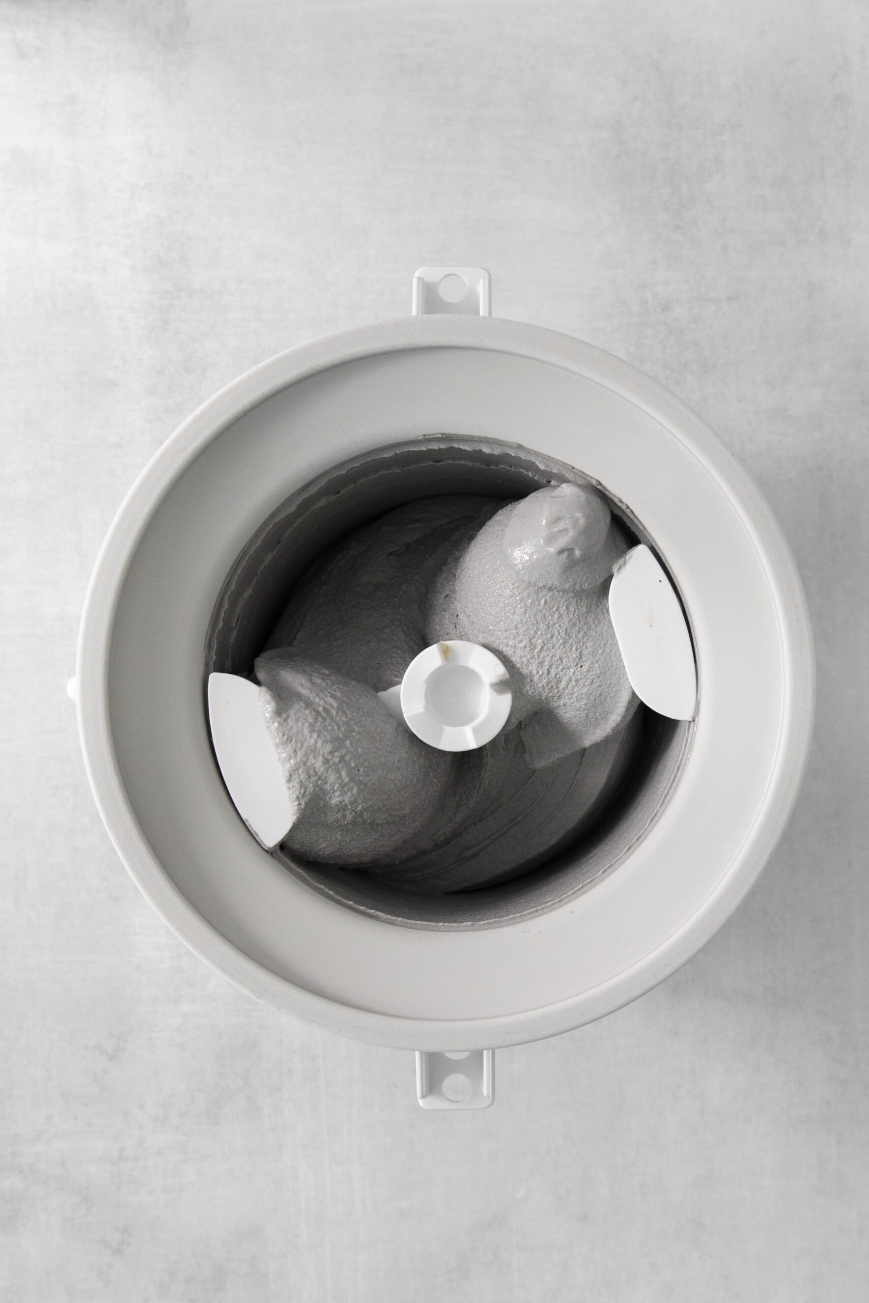 black ice cream mixture in a ice cream machine bowl