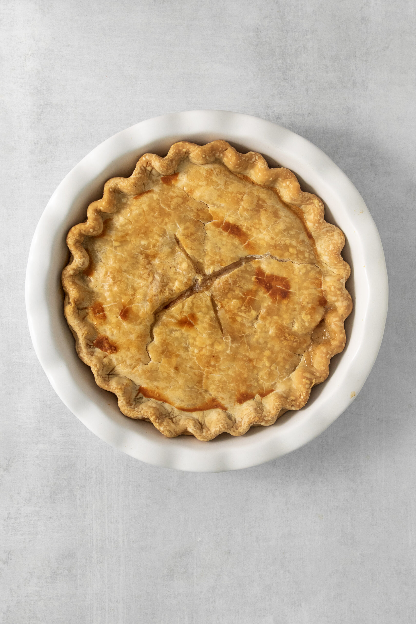 baked peach pie with canned peaches in a pie pan
