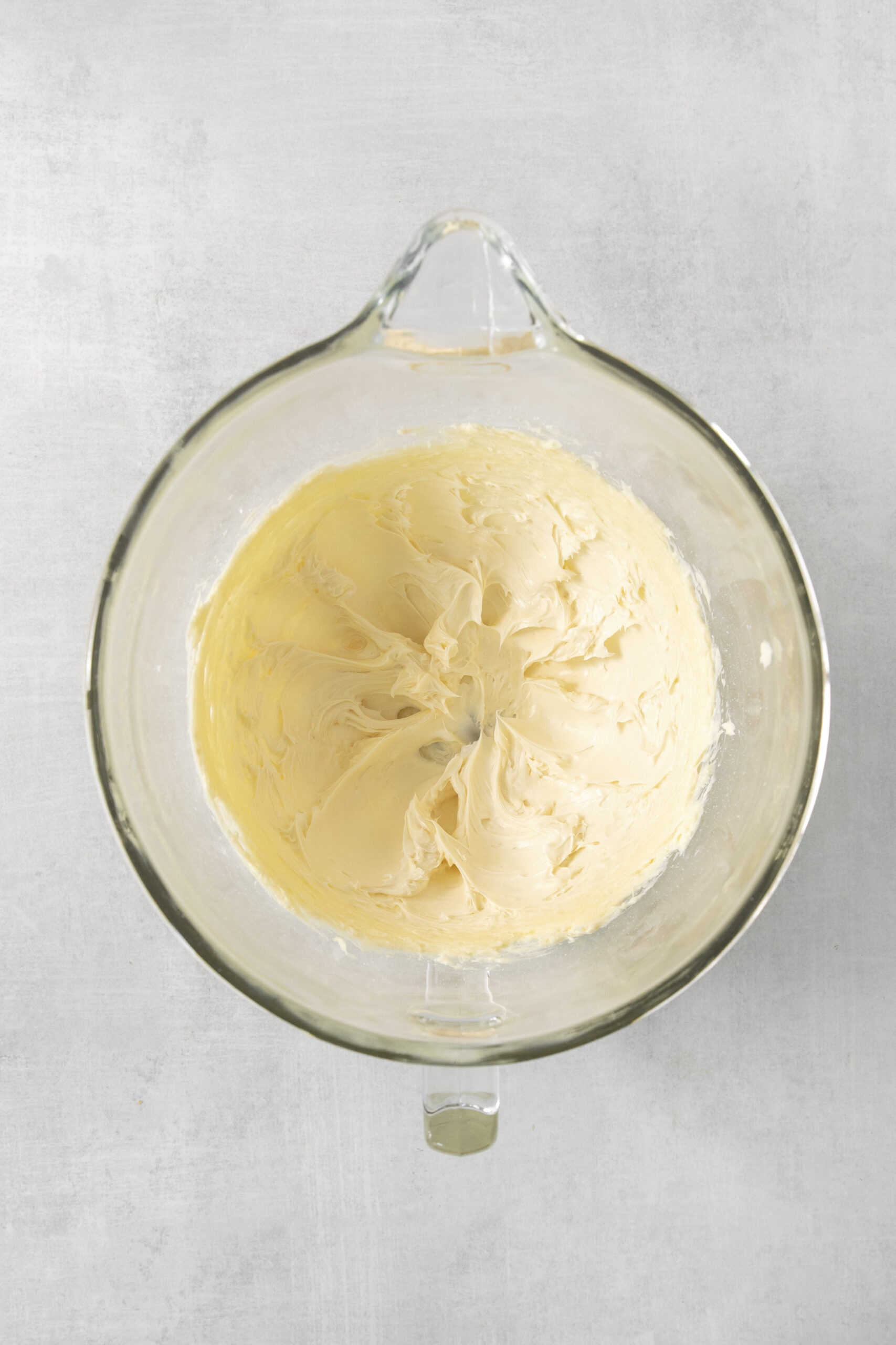 butter and sugar creamed in a clear mixing bowl